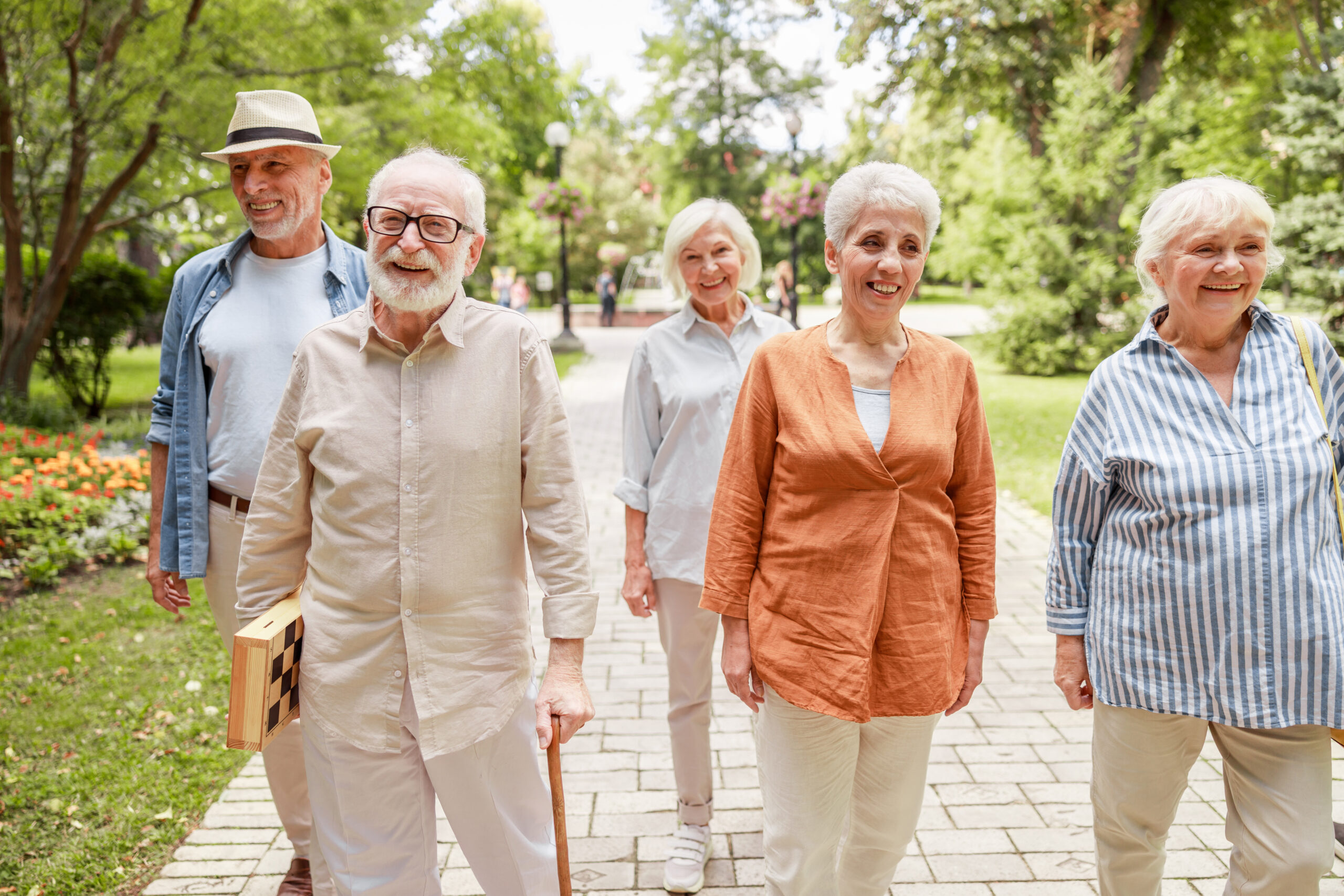 Cheerful senior people strolling through the park